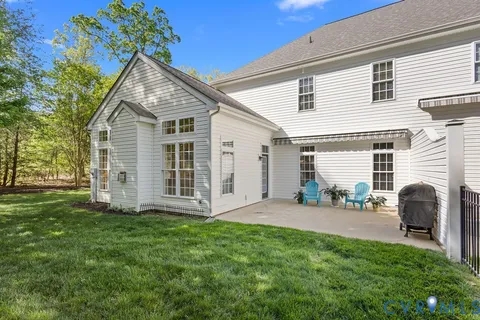 a backyard of a house with table and chairs