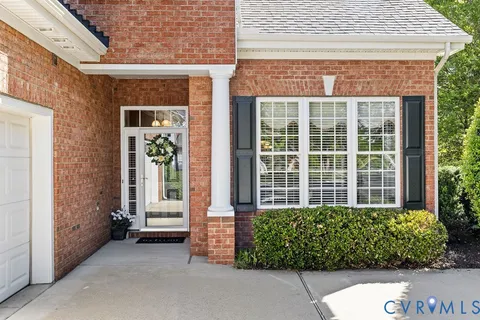 front view of a brick house with a large window