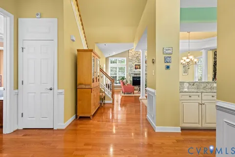 a living room with stainless steel appliances kitchen island granite countertop furniture and a fireplace