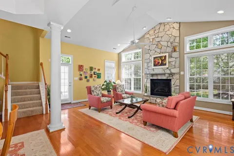 a living room with furniture fireplace and a table