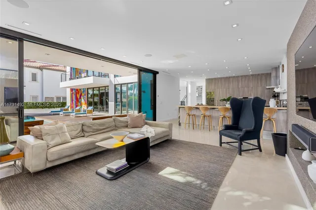 a kitchen with stainless steel appliances kitchen island granite countertop a refrigerator and a sink