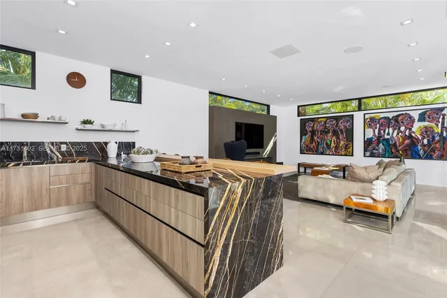 a kitchen with stainless steel appliances kitchen island granite countertop a sink and cabinets