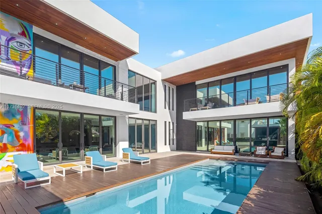 a view of a house with a swimming pool and porch