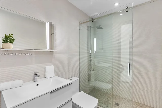 a bathroom with a sink toilet and shower