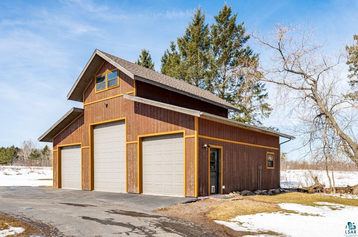 27 West Stark Road Esko, MN 55733 - Photo 42 of 47 Snow covered garage featuring a garage