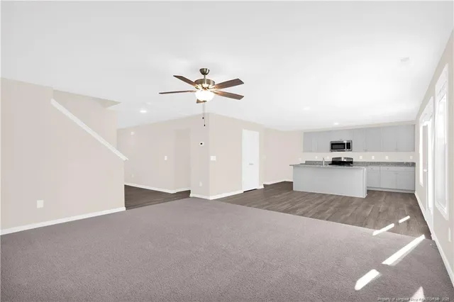a kitchen with stainless steel appliances granite countertop white cabinets and stove
