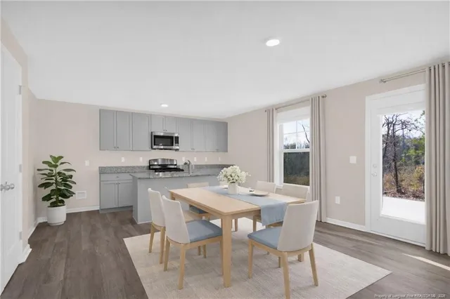 a view of a dining room with furniture window and wooden floor