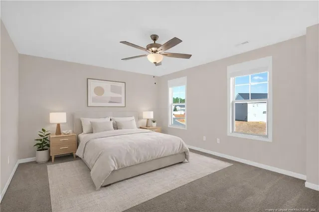 a bedroom with a bed chandelier and a window