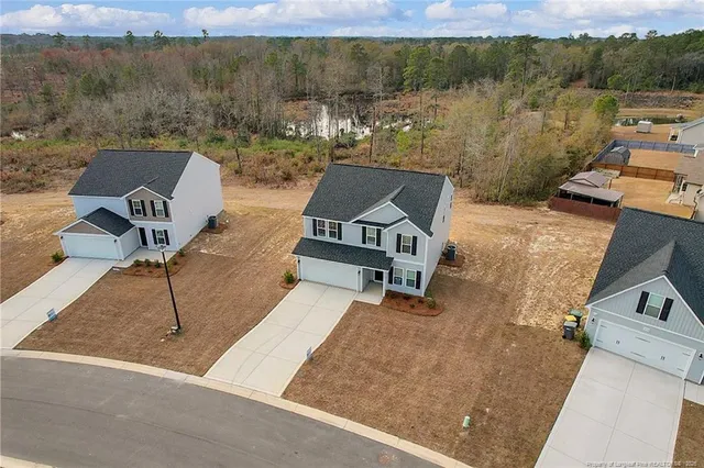 an aerial view of a house with a yard