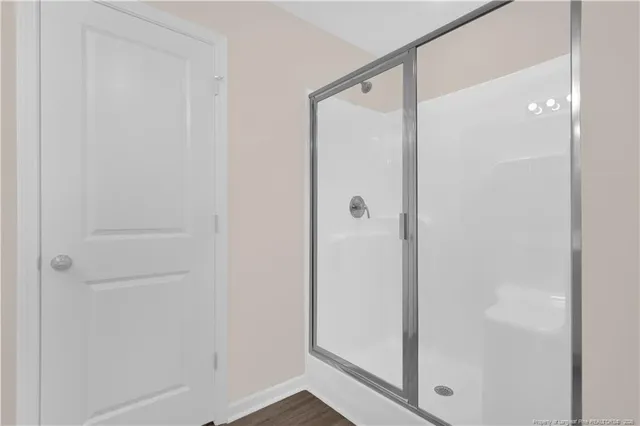 a bathroom with a glass shower door