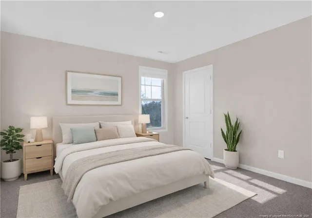 a bedroom with a bed and a potted plant