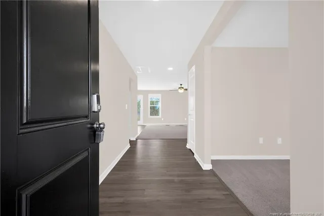 an empty room with fan and windows