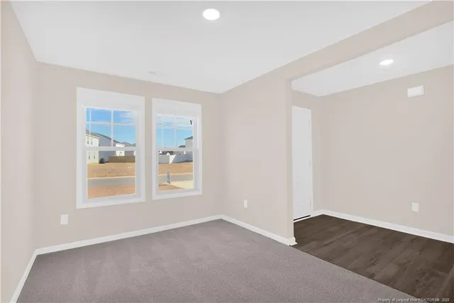 a view of an empty room with a kitchen