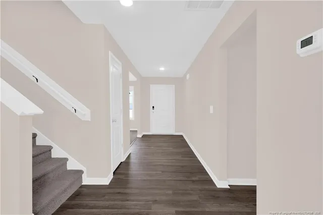 a view of a hallway with the wooden floor