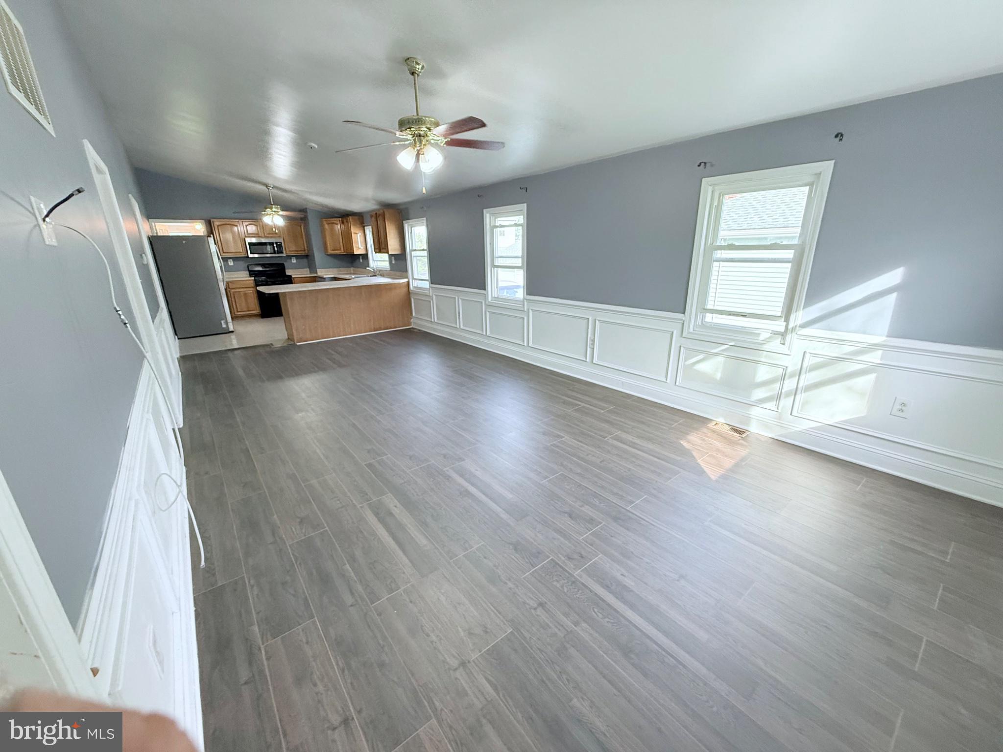 Spacious, sunlit open living area.