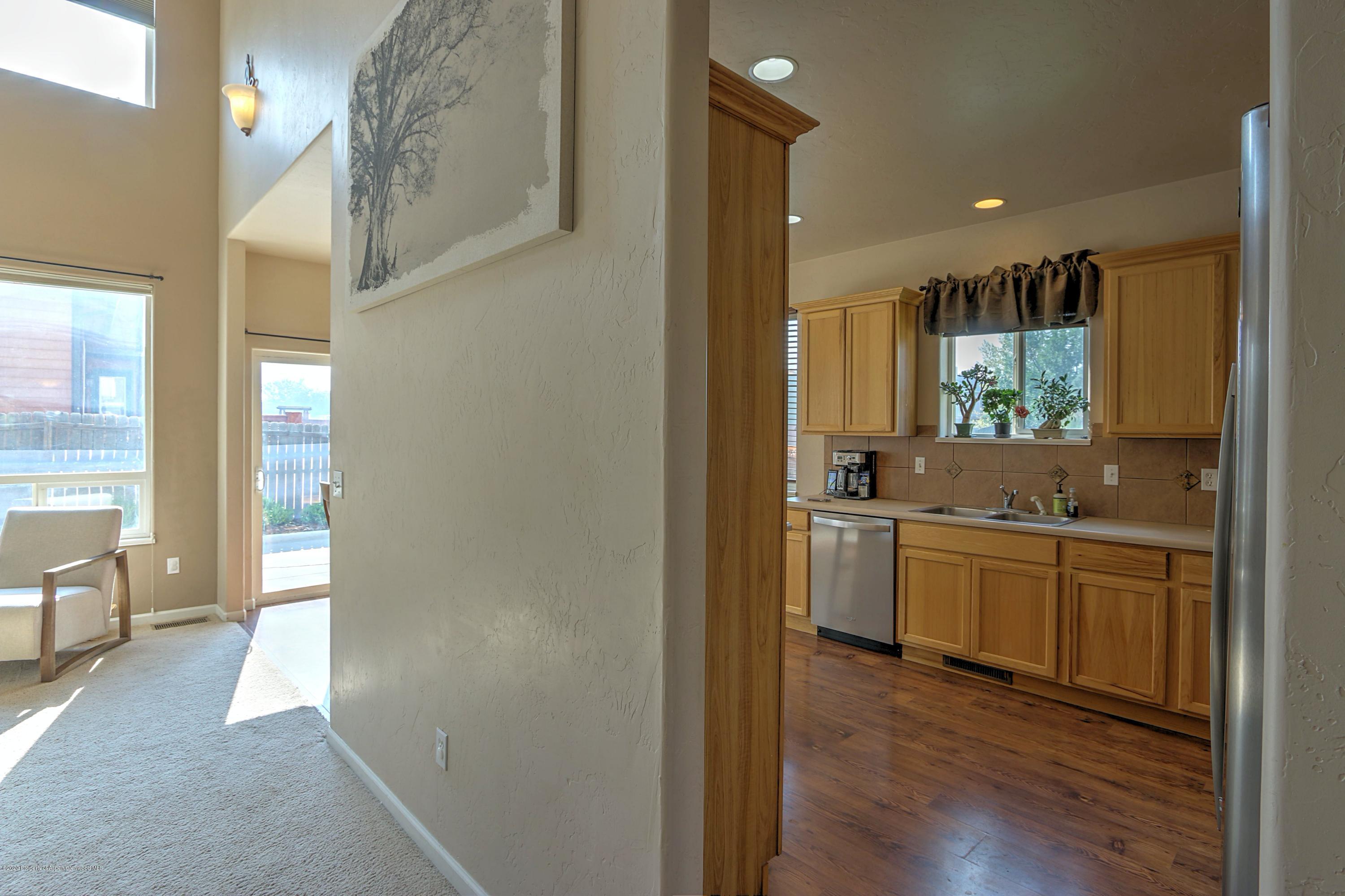 1600 Anvil View Avenue Rifle, CO 81650 - Photo 4 of 22 a kitchen with white cabinets and wooden floor