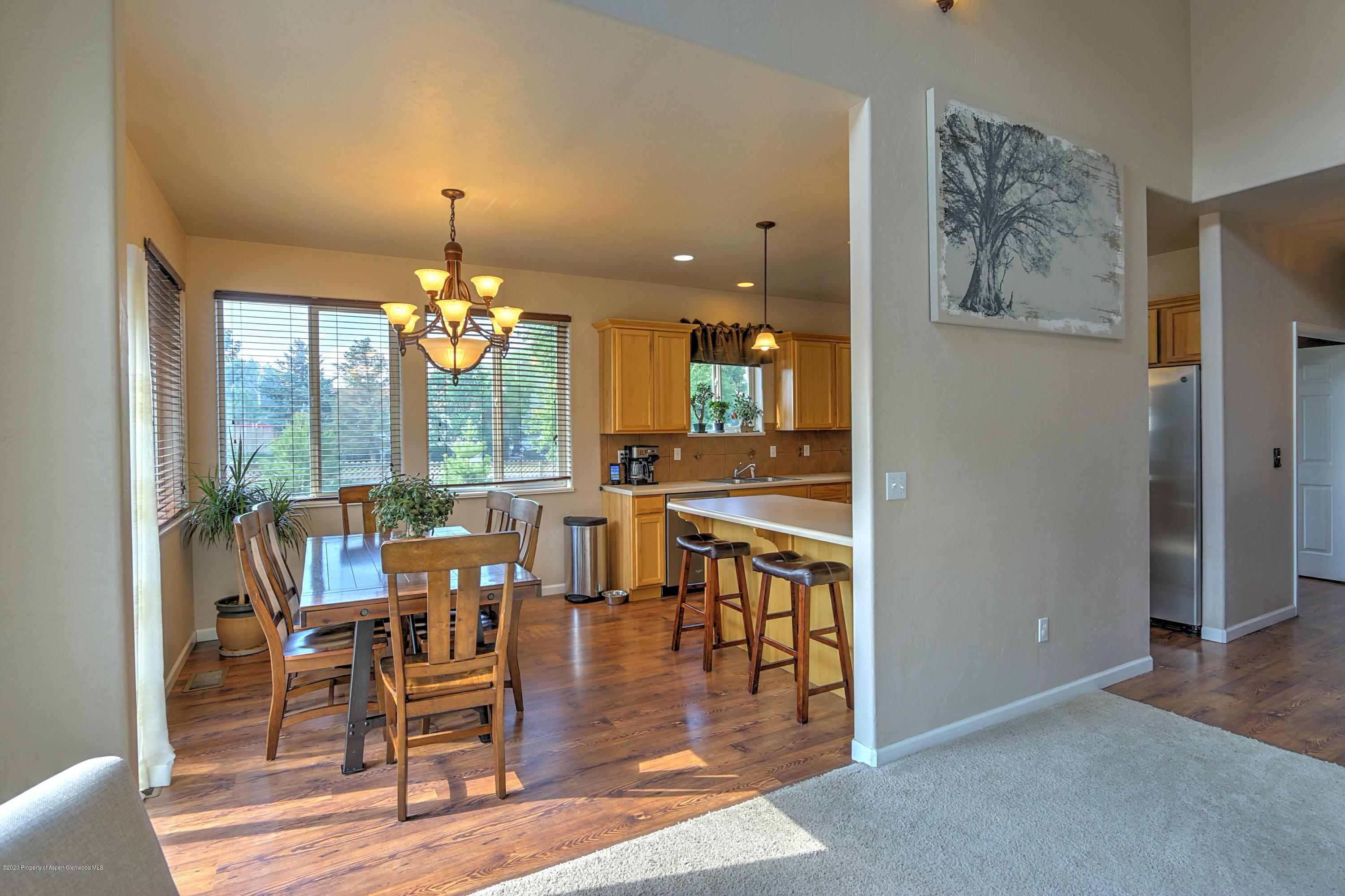 1600 Anvil View Avenue Rifle, CO 81650 - Photo 8 of 22 a view of a dining room with furniture window and wooden floor