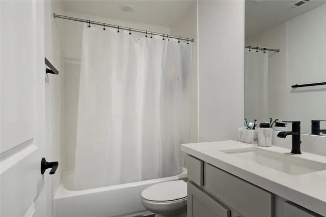 a bathroom with a sink a toilet and a bathtub