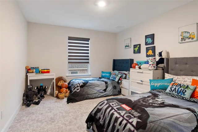 a bedroom with two beds and a computer on a bed