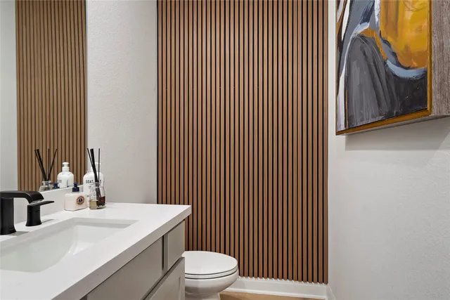 a bathroom with a sink a toilet and mirror