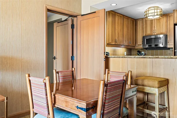 a dining room with furniture and a window