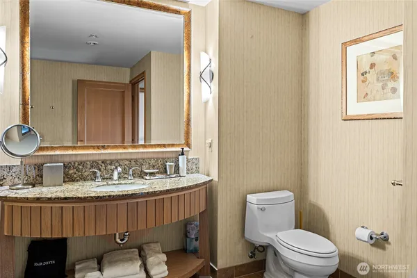 a bathroom with a sink a toilet and a mirror
