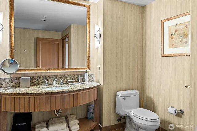 a bathroom with a sink a toilet and a mirror