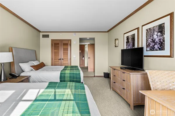 a bedroom with furniture and a flat screen tv