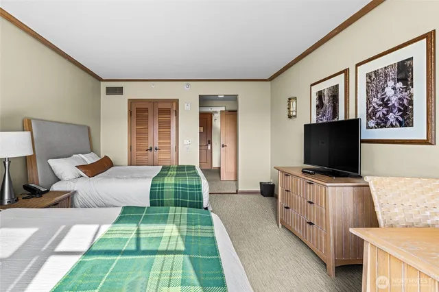 a bedroom with furniture and a flat screen tv