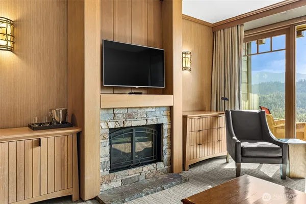 a living room with furniture a flat screen tv and a fireplace