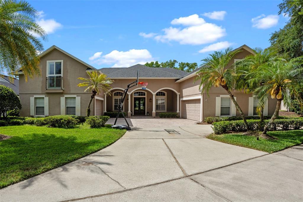 5108 Sailwind Circle Orlando, FL 32810 - Photo 1 of 1 a view of house with garden and tall tress