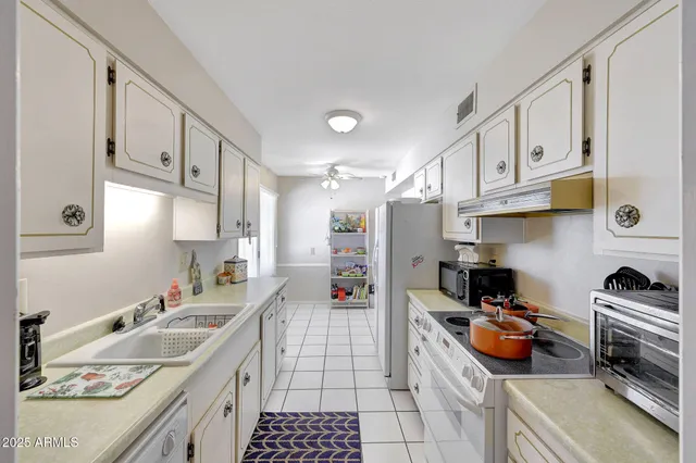 a kitchen with stainless steel appliances granite countertop a sink and cabinets
