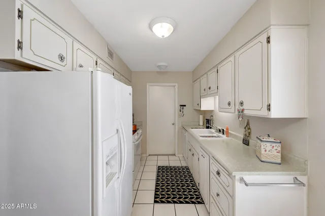a kitchen with a sink a stove and refrigerator