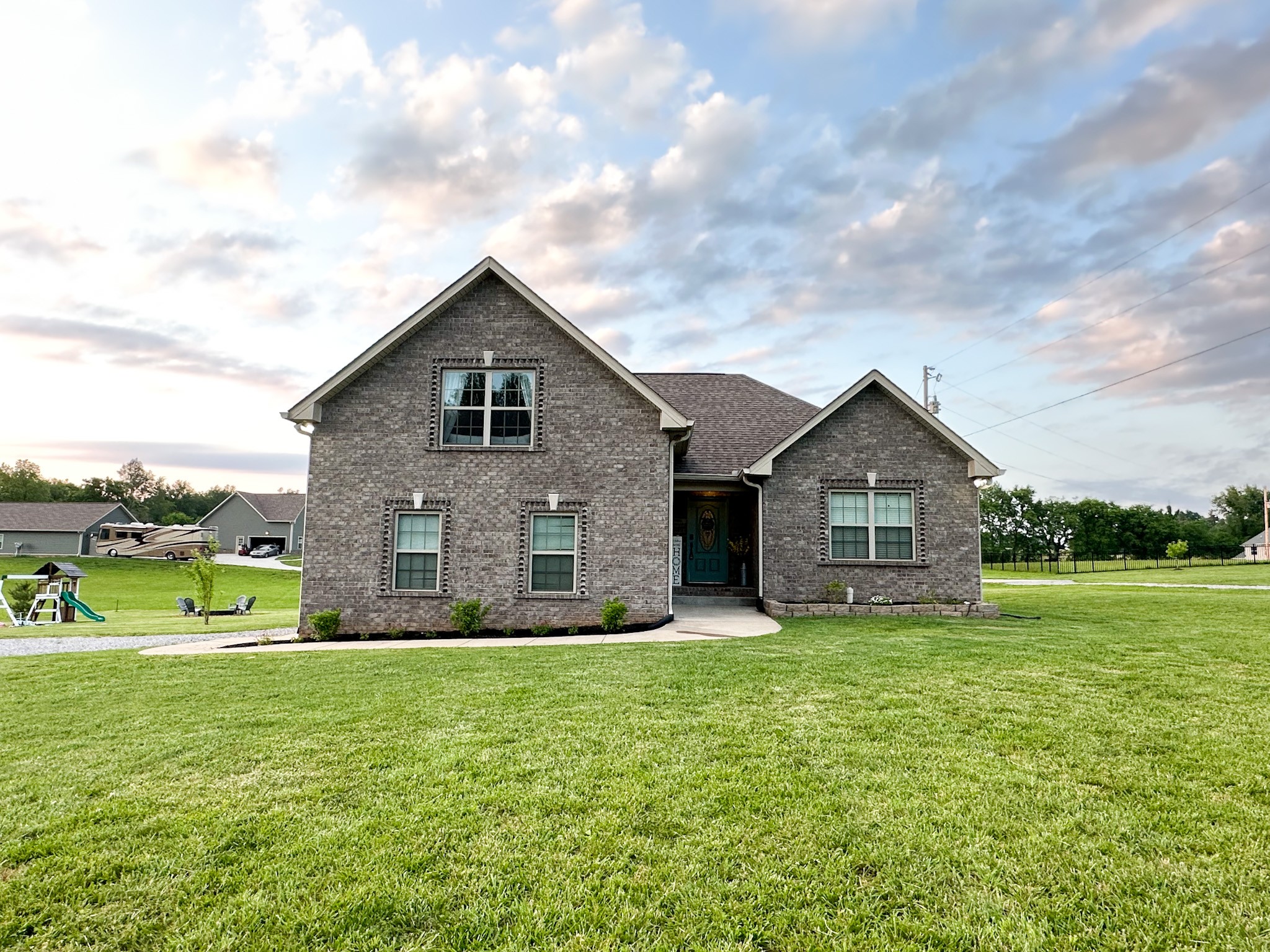 a front view of house with yard and green space
