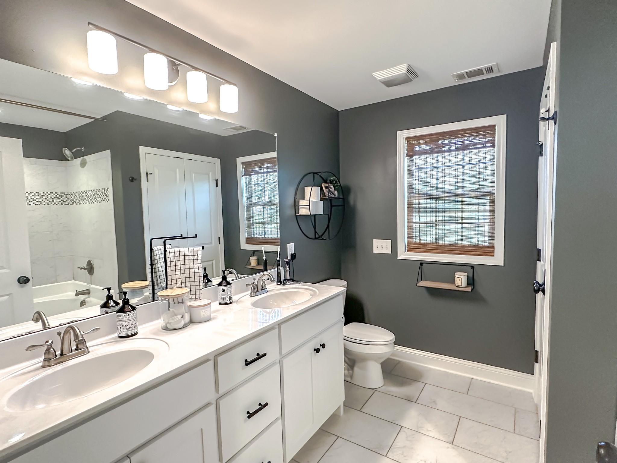 4927 Minnis Road Springfield, TN 37172 - Photo 17 of 27 a spacious bathroom with a double vanity sink a toilet and a mirror