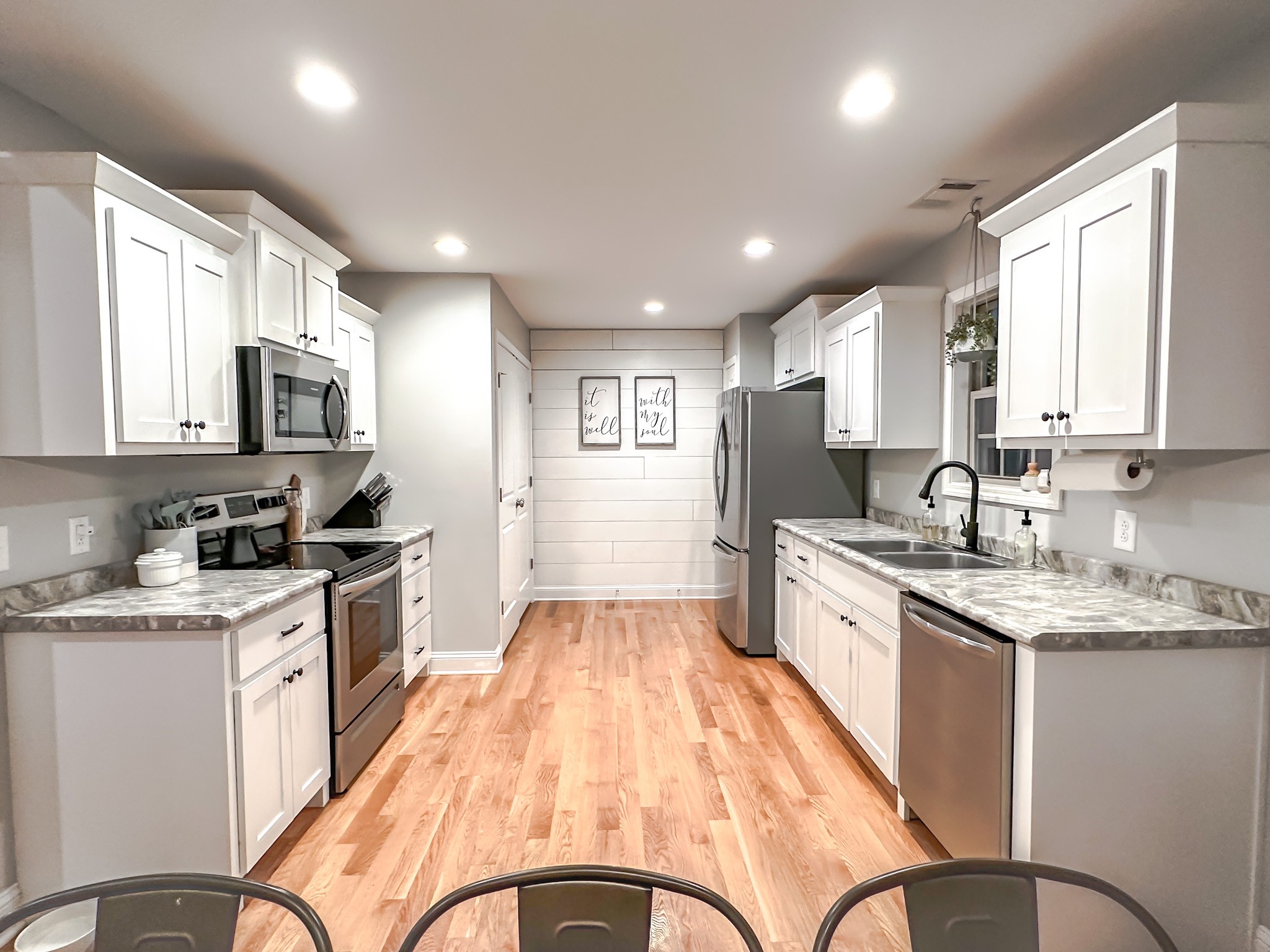 4927 Minnis Road Springfield, TN 37172 - Photo 9 of 27 a large kitchen with stainless steel appliances granite countertop a stove a sink dishwasher a microwave oven with a dining table and chairs