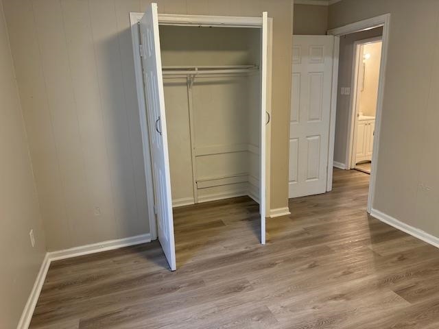4571 Sea Isle Road Memphis, TN 38117 - Photo 11 of 12 an empty room with wooden floor closet and windows