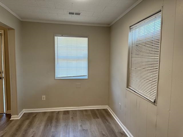 4571 Sea Isle Road Memphis, TN 38117 - Photo 5 of 12 an empty room with wooden floor and windows