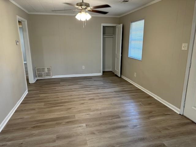 4571 Sea Isle Road Memphis, TN 38117 - Photo 6 of 12 a view of an empty room with wooden floor and a window