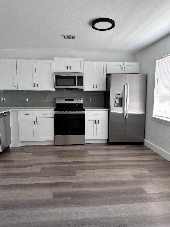 1830 River Crossing Circle, Unit C Austin, TX 78741 - Photo 5 of 16 a kitchen with stainless steel appliances a refrigerator sink and cabinets