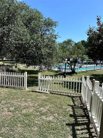 a view of a deck with a white fence