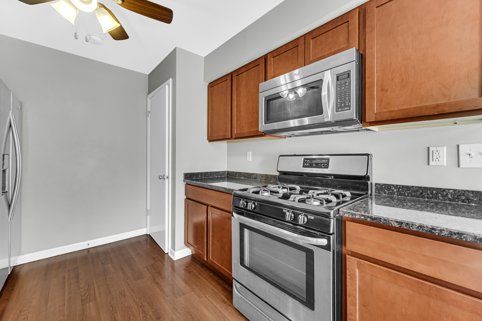 601 Northgate Road, Unit 601 New Lenox, IL 60451 - Photo 11 of 21 a kitchen with stainless steel appliances granite countertop a stove and a microwave