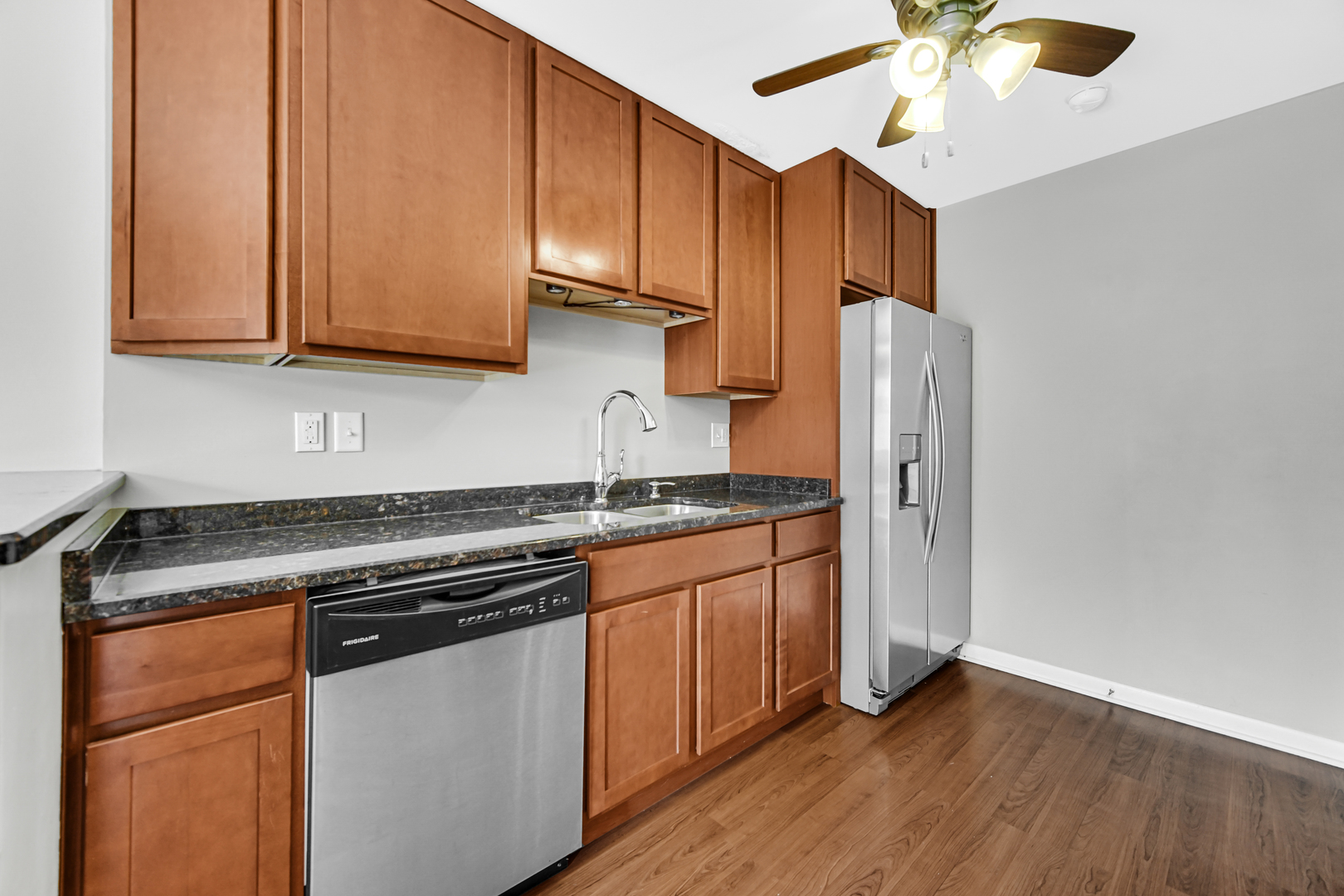601 Northgate Road, Unit 601 New Lenox, IL 60451 - Photo 9 of 21 a kitchen with stainless steel appliances granite countertop wooden cabinets a refrigerator a sink and a stove
