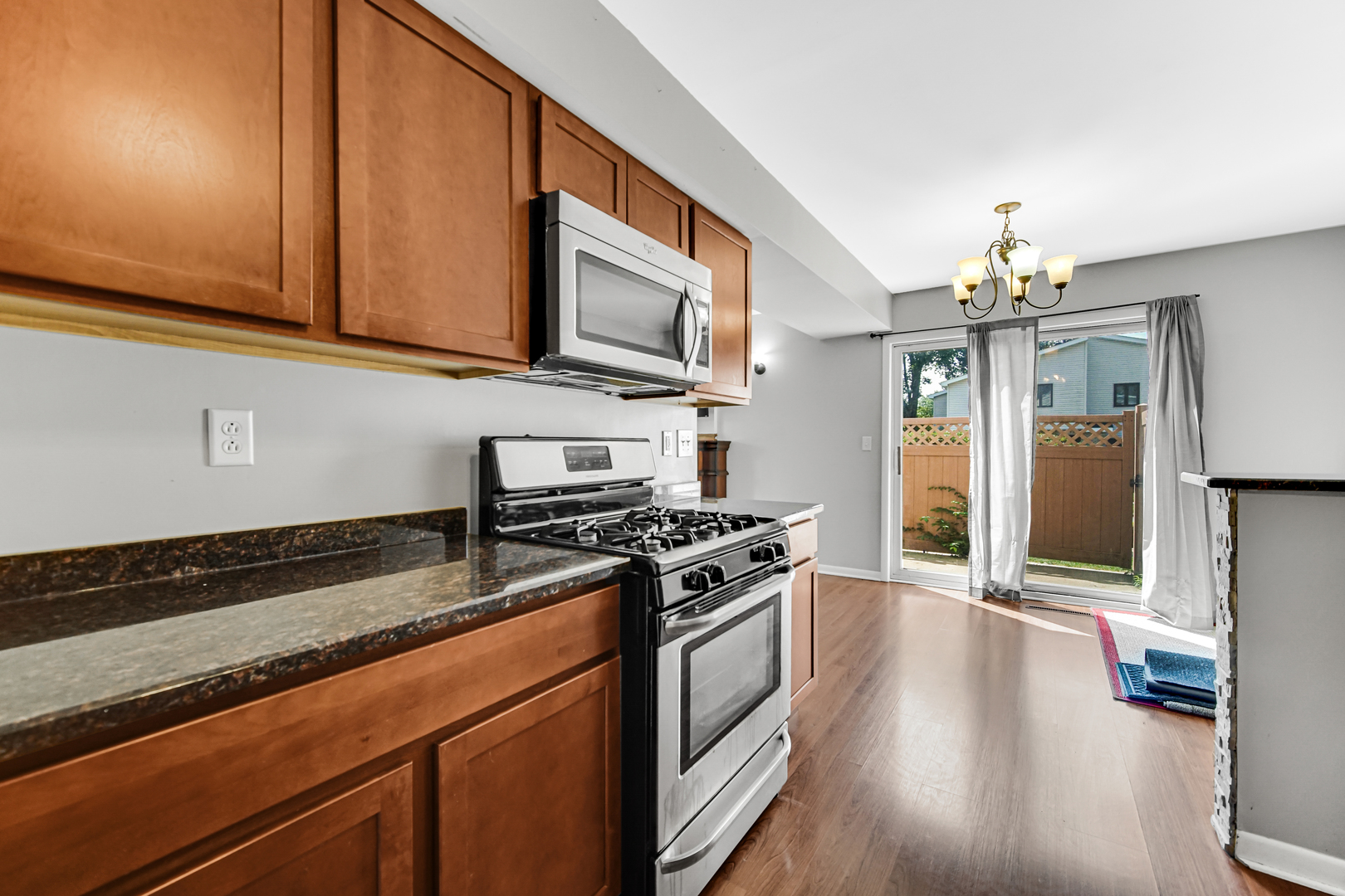601 Northgate Road, Unit 601 New Lenox, IL 60451 - Photo 10 of 21 a kitchen with stainless steel appliances granite countertop a stove and a wooden cabinets