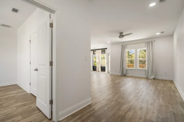 a view of kitchen with refrigerator and cabinets