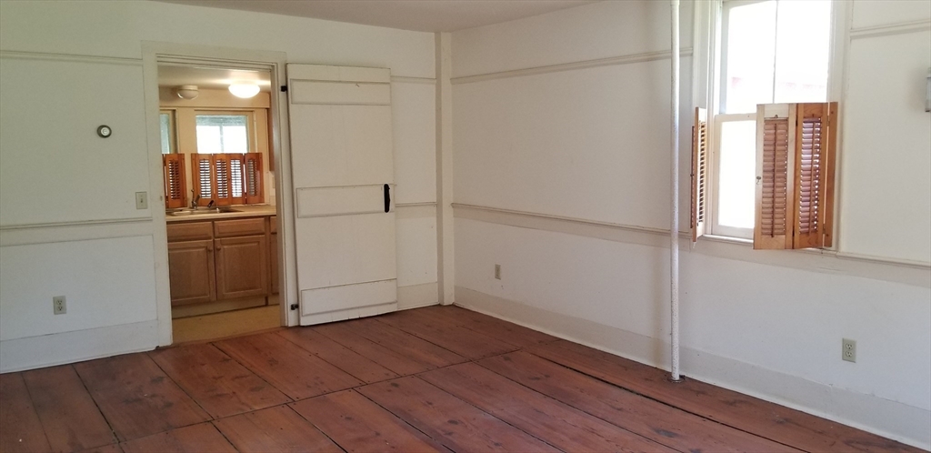16 Amherst Road Pelham, MA 01002 - Photo 7 of 17 a view of empty room with wooden floor and window