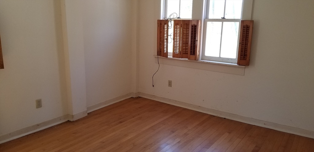 16 Amherst Road Pelham, MA 01002 - Photo 8 of 17 an empty room with wooden floor and windows
