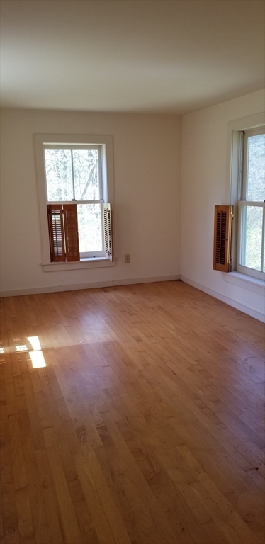 16 Amherst Road Pelham, MA 01002 - Photo 9 of 17 an empty room with windows and fireplace