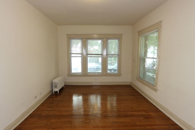 4716 North Racine Avenue, Unit 2E Chicago, IL 60640 - Photo 17 of 19 a view of empty room with wooden floor and fan