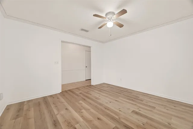 an empty room with a empty space and a ceiling fan